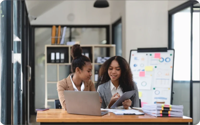 two-young-business-people-working-together-in-offi